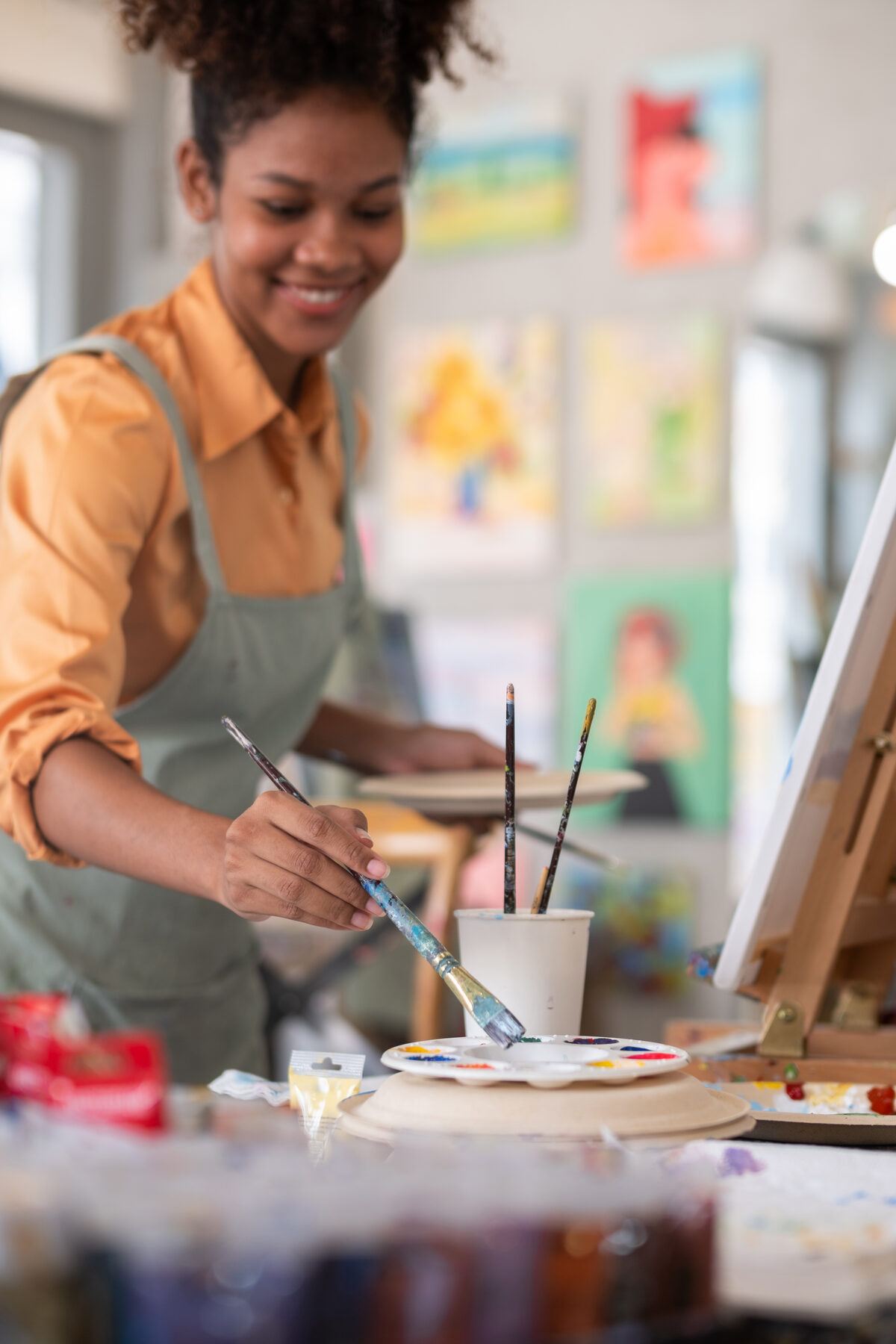 Portrait of featured artist Whitney Combs at her easel